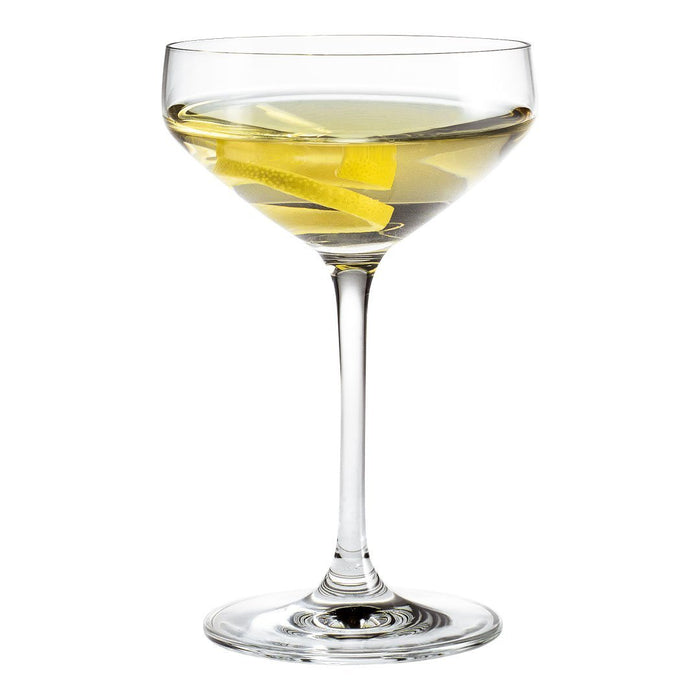 Elegant clear cocktail glass with a minimalist design, featuring a light yellow drink and lemon twist garnish.
