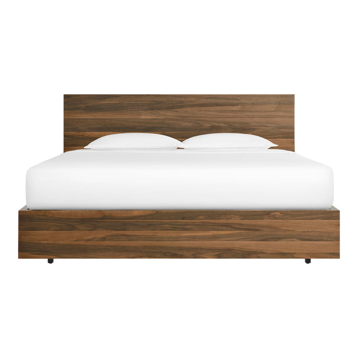 Modern wooden bed in a rich walnut finish with a smooth, minimalist design and crisp white bedding.
