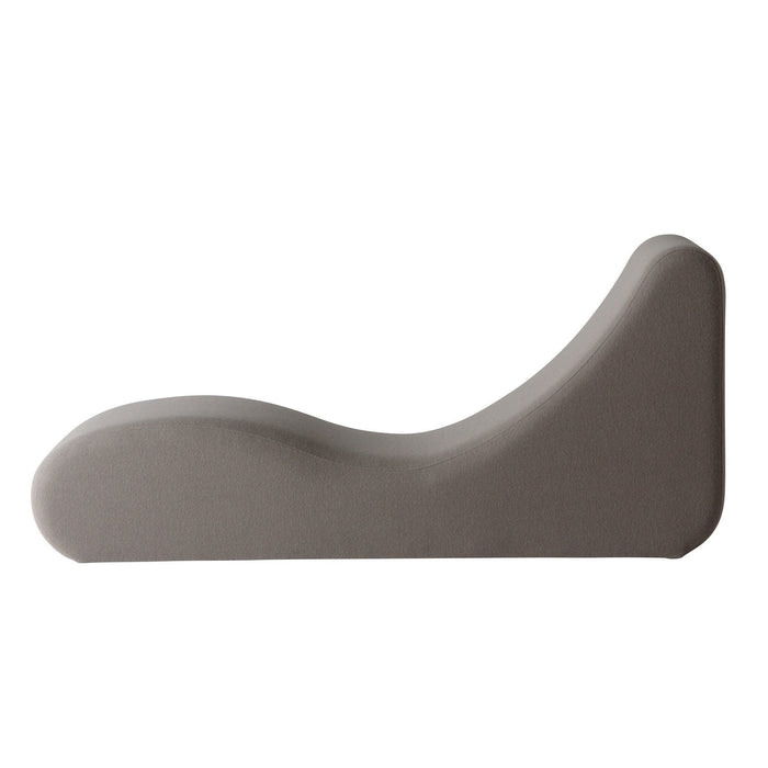 Gray sculptural lounge chair with smooth, minimalist contours and a soft fabric finish, perfect for modern decor.