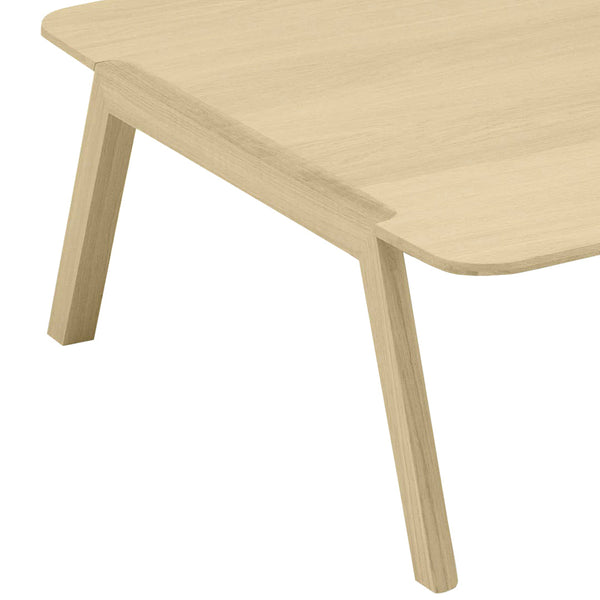 Light beige wood coffee table with smooth edges and angular legs, showcasing a minimalist design.