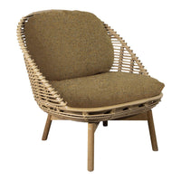 Cozy wicker chair with a textured brown cushion and light wood legs, perfect for a bohemian-inspired decor.