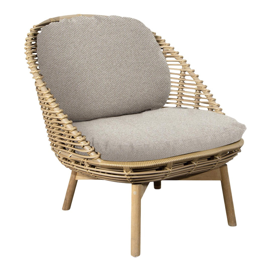 Natural woven rattan chair with a soft gray cushion for a cozy, modern look. Ideal for stylish living spaces.