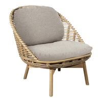 Natural woven rattan chair with a soft gray cushion for a cozy, modern look. Ideal for stylish living spaces.