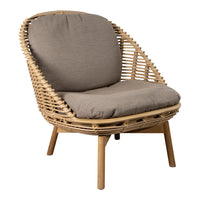 Natural rattan chair with a beige cushion and smooth, curved design. Perfect for modern and cozy interiors.