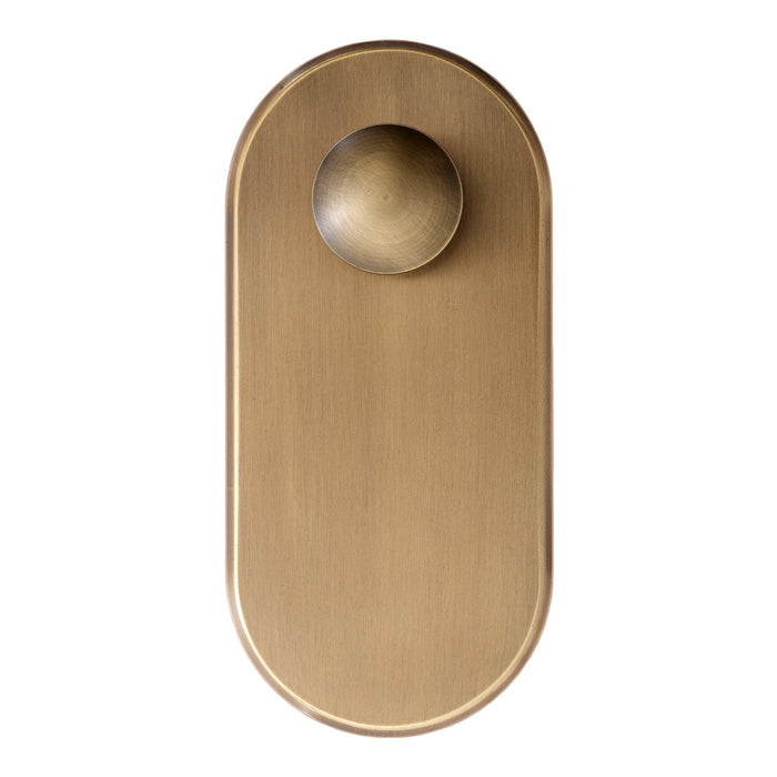Brushed brass door knob with a smooth, round handle and oval backplate for a modern, elegant finish.