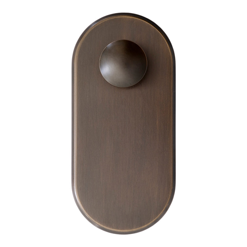 Bronze oval door knob with a smooth finish and matching plate, featuring a minimalist design. Ideal for modern decor.