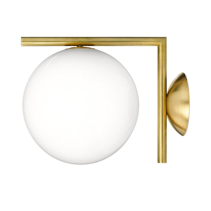 Modern brass wall sconce featuring a sleek gold frame and a smooth white globe pattern.