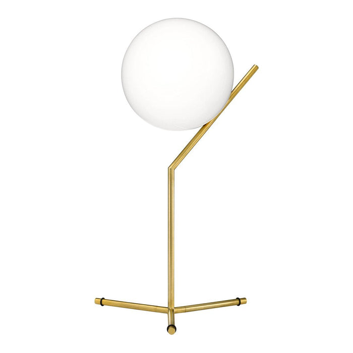 Gold lamp with a minimalist design featuring a white globe shade and sleek geometric lines.