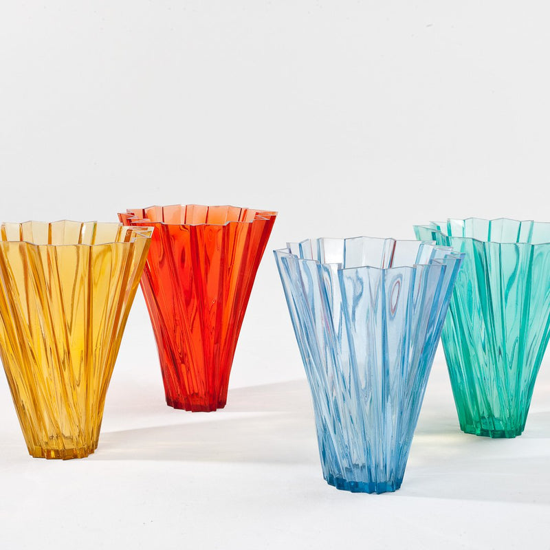 Colorful textured vases in yellow, red, blue, and green with unique fluted patterns, perfect for vibrant decor.