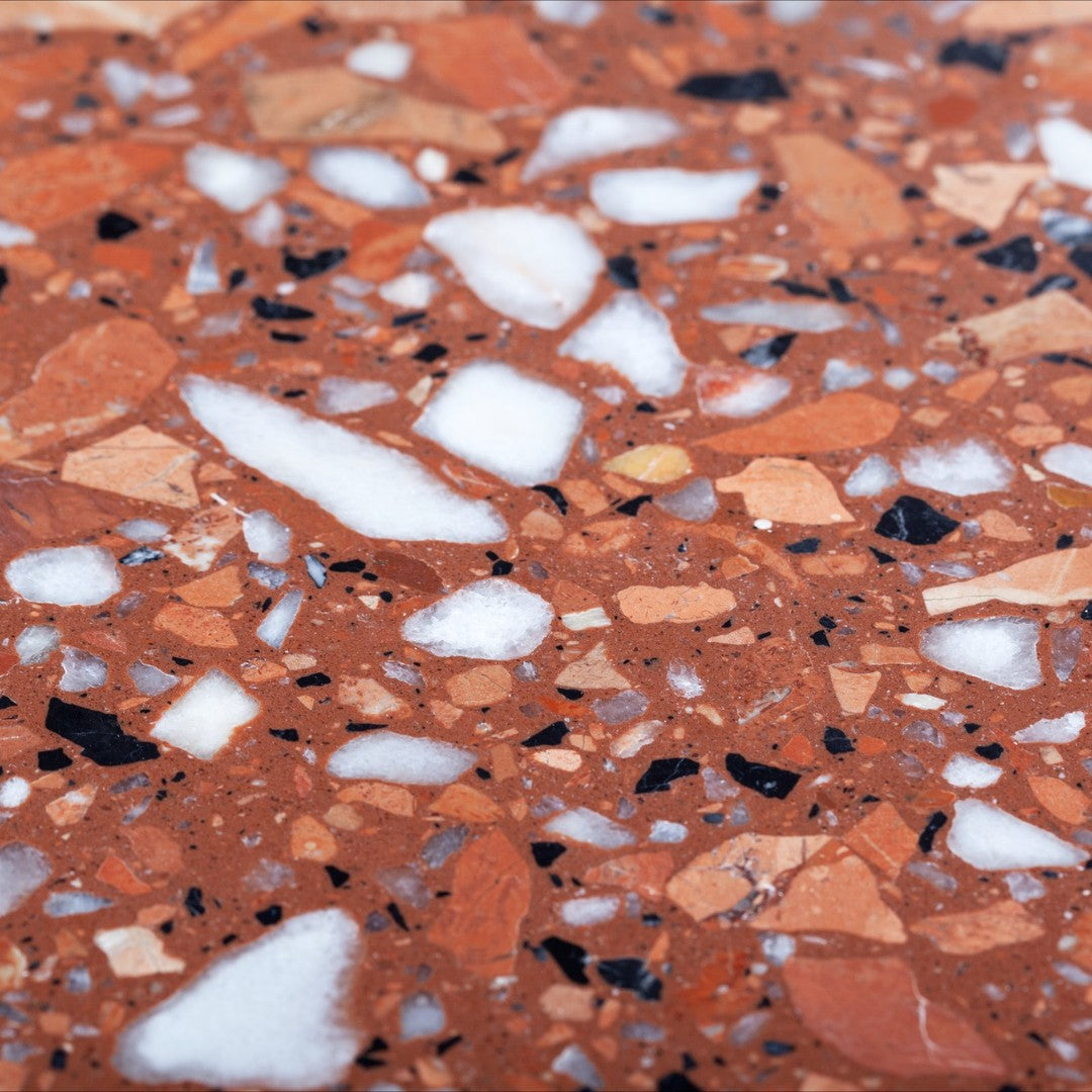 Terrazzo surface with brown, white, and black fragments. Unique speckled pattern adds a stylish touch to decor.