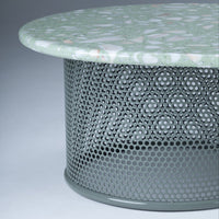 Green patterned tabletop with a geometric grey mesh base, creating a modern and stylish look.