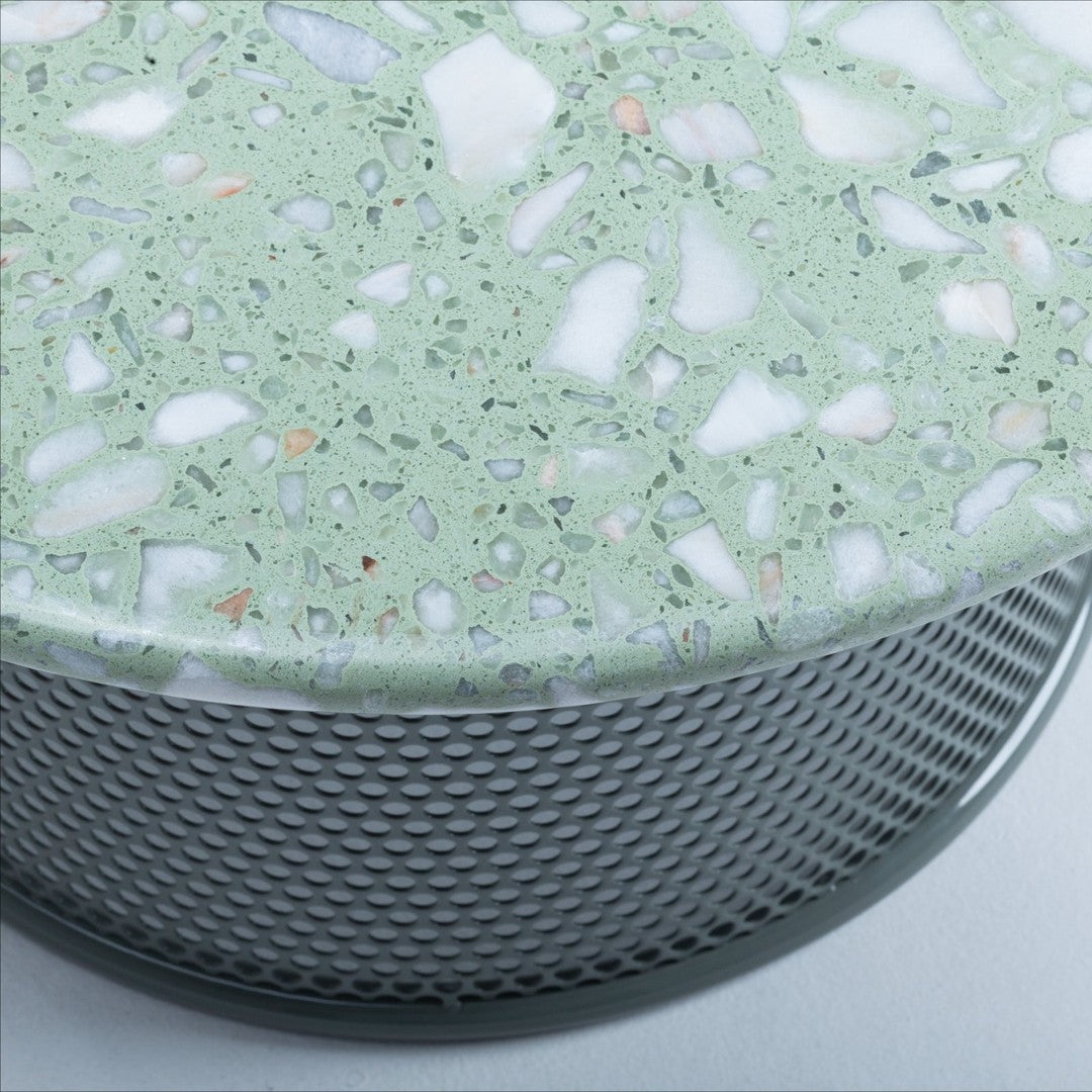 Light green terrazzo top with scattered white and colorful stone fragments, set on a textured silver mesh base.
