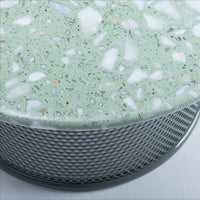 Light green terrazzo top with scattered white and colorful stone fragments, set on a textured silver mesh base.