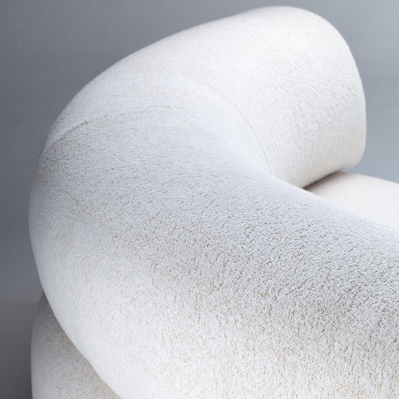 Textured off-white fabric in a curved shape, featuring soft, subtle variations in tone. Perfect for modern decor.