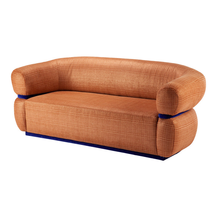 Rust-orange sofa with a textured pattern and contrasting blue trim, featuring rounded arms and a modern design.
