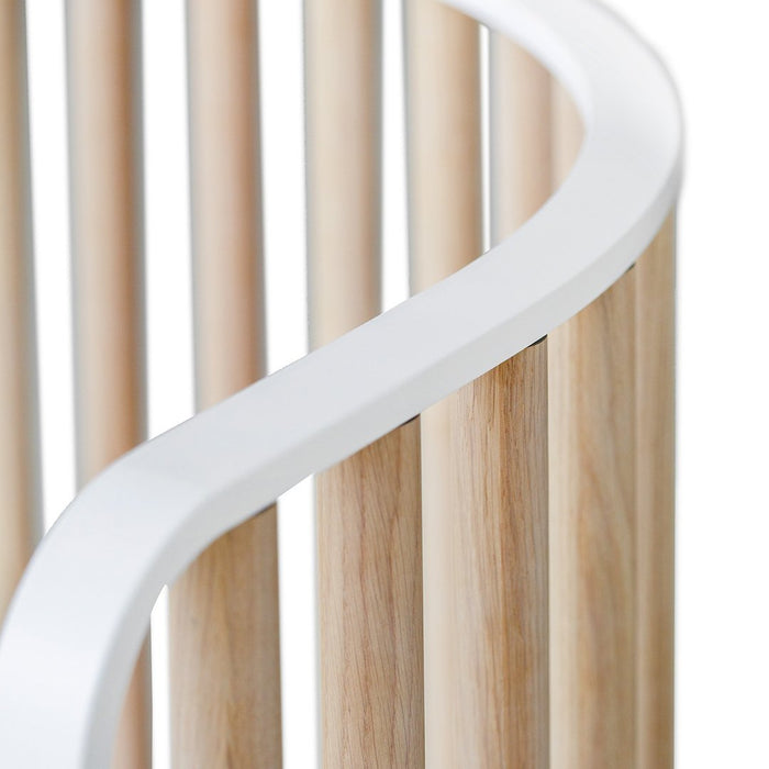 Light wood with smooth white accents, featuring a minimalist design and curved lines. Perfect for modern nurseries.