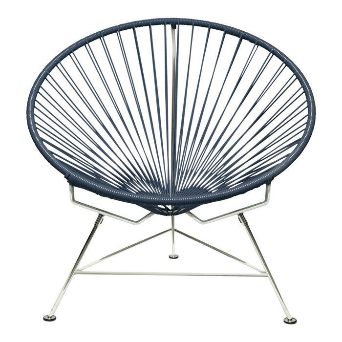 Navy blue Acapulco chair with distinctive radial pattern and sleek silver metal base. Perfect for modern decor.