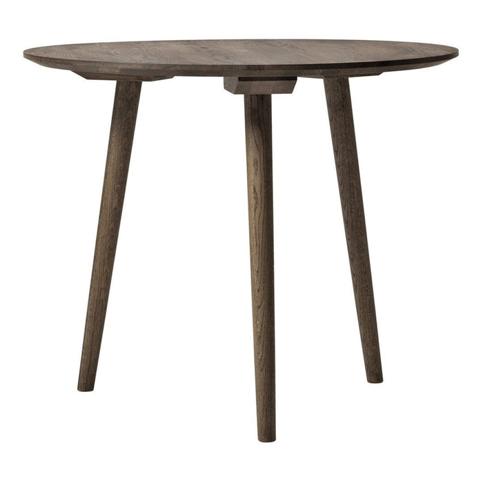 Round wooden table in a dark brown finish with a smooth surface and sleek, tapered legs. Perfect for modern decor.