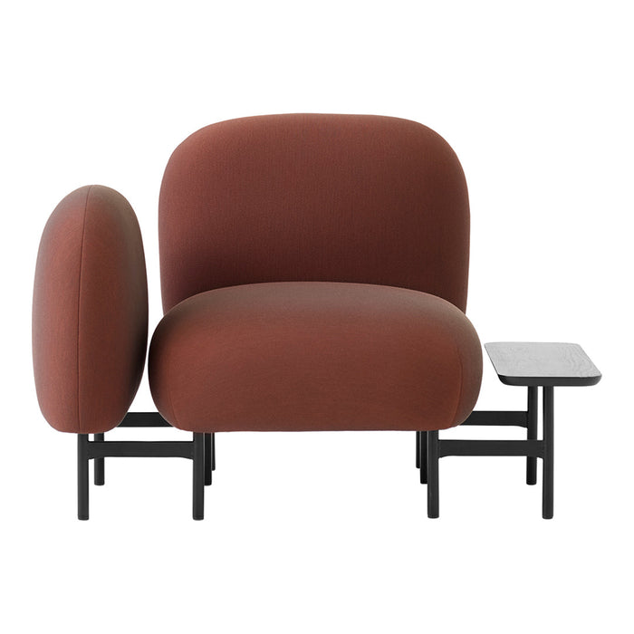 Modern plush chair in warm brown tones with smooth, rounded shapes and sleek black metal legs.