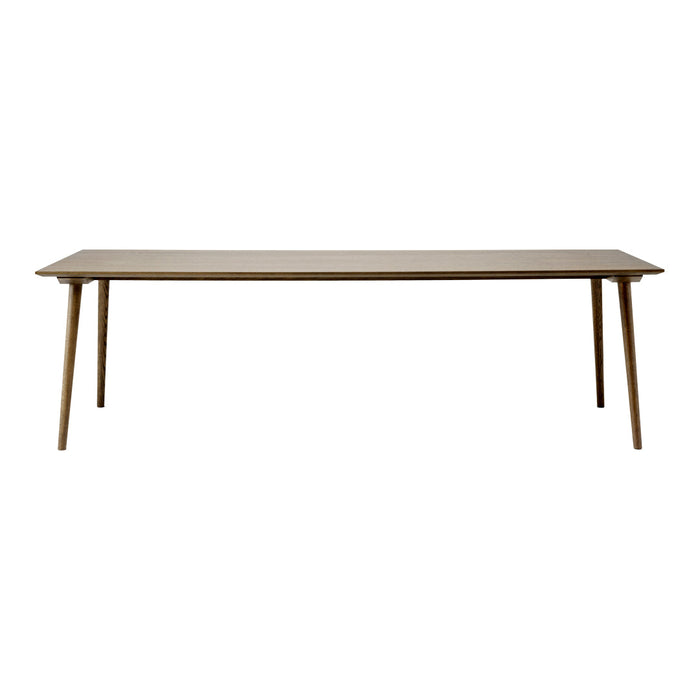 Light brown rectangular table with smooth surface and tapered wooden legs, showcasing a minimalist design.