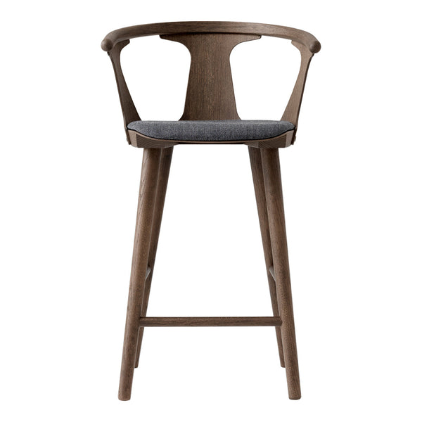 "Natural wood finish bar stool with a gray upholstered seat, showcasing a modern, minimalist design."