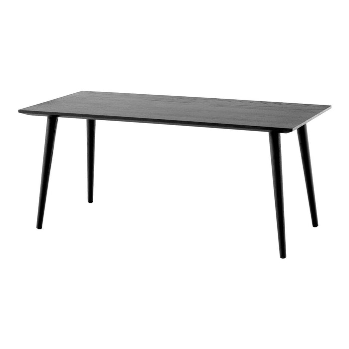 Black rectangular table with smooth surface and tapered legs, featuring a minimalist design.