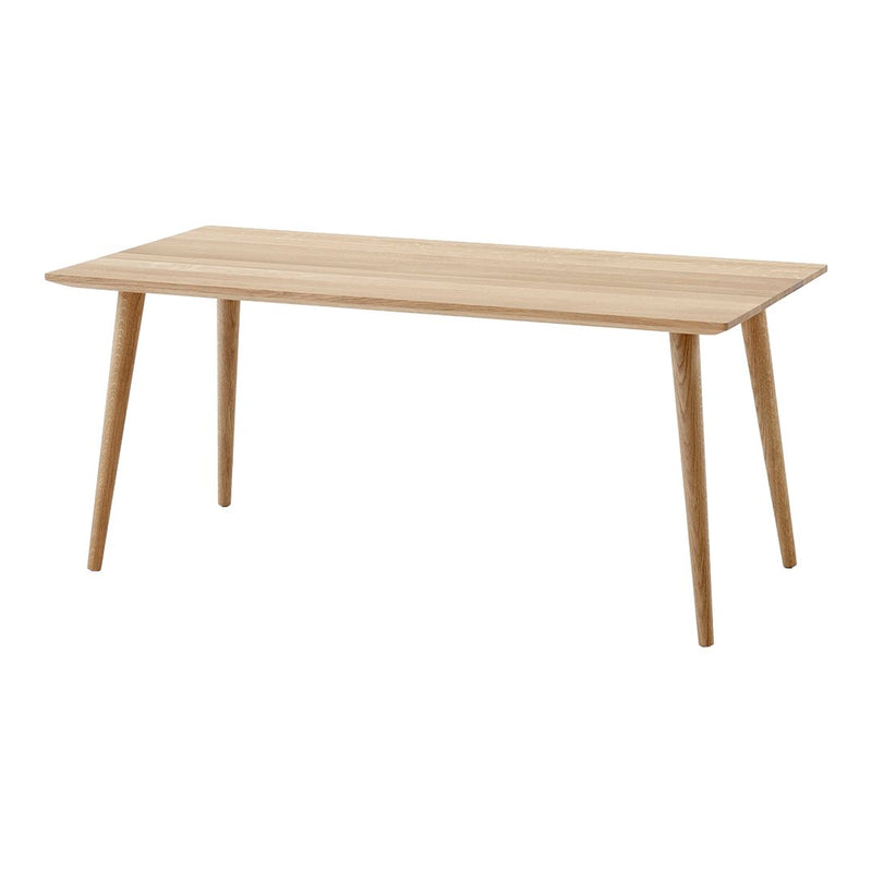 Light wood dining table with natural grain, featuring a sleek, minimalist design and tapered legs.