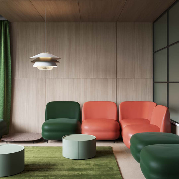 Colorful modern seating in green, orange, and mint accents, paired with a soft green area rug in a sleek interior.