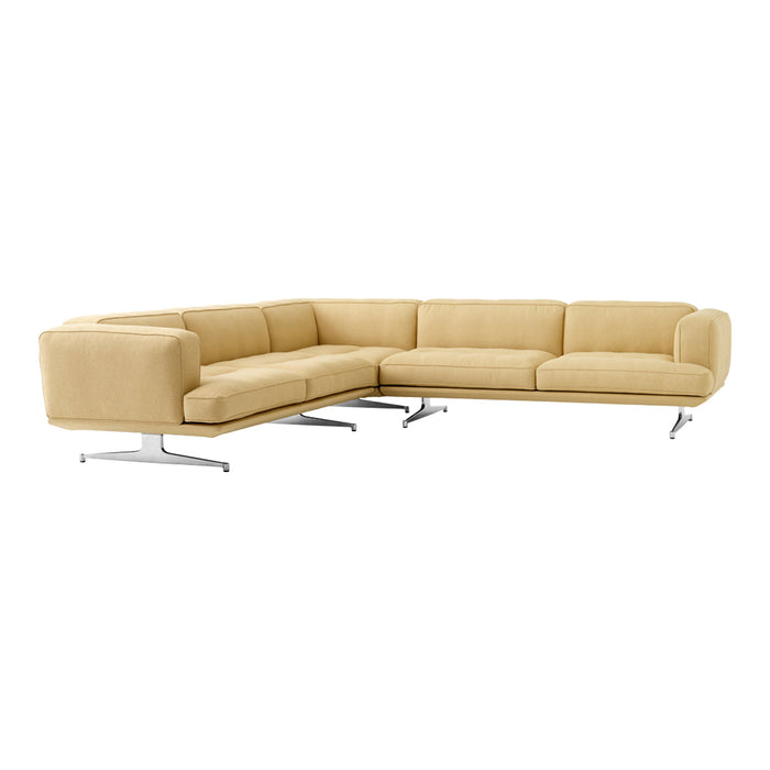 "Light yellow sectional sofa with smooth fabric and minimalist design, featuring chrome legs for a modern look."
