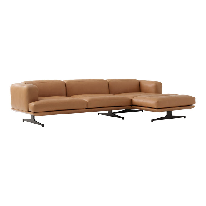 Tan leather sectional sofa with modern black metal legs, featuring a sleek, minimalist design and smooth texture.