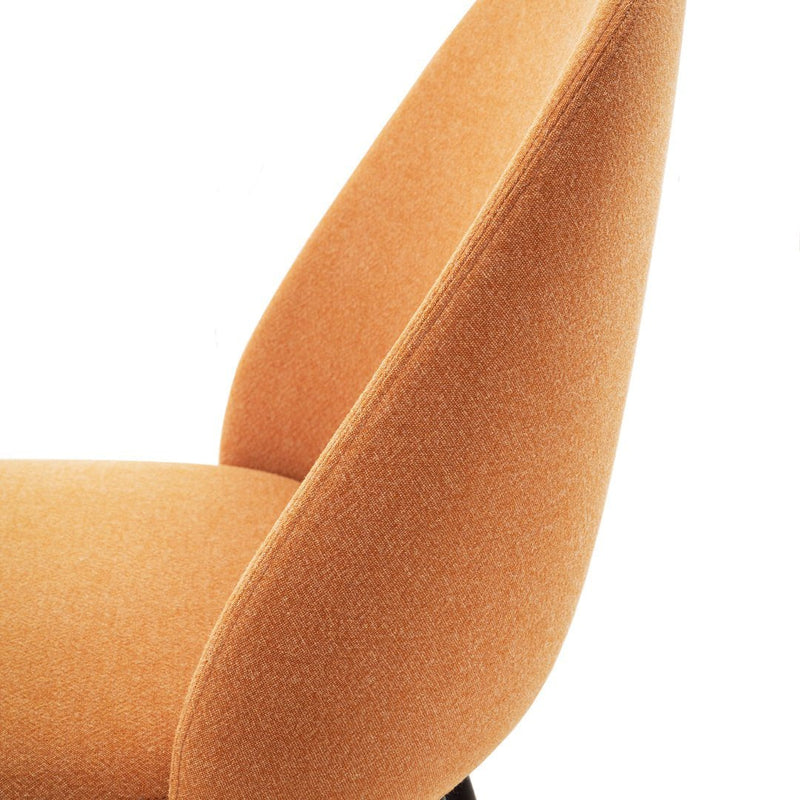 Orange textured chair with a sleek, modern design, featuring smooth curves and soft fabric finish.