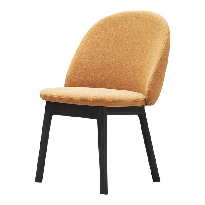 Velvety mustard yellow chair with sleek black legs, perfect for modern home decor.