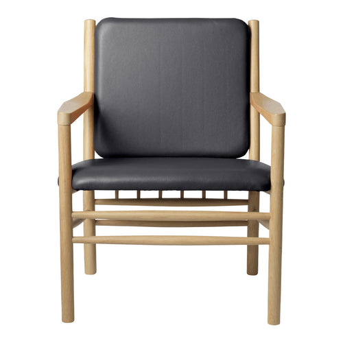 Black leather armchair with natural wood frame, featuring a sleek, minimalist design and no intricate patterns.