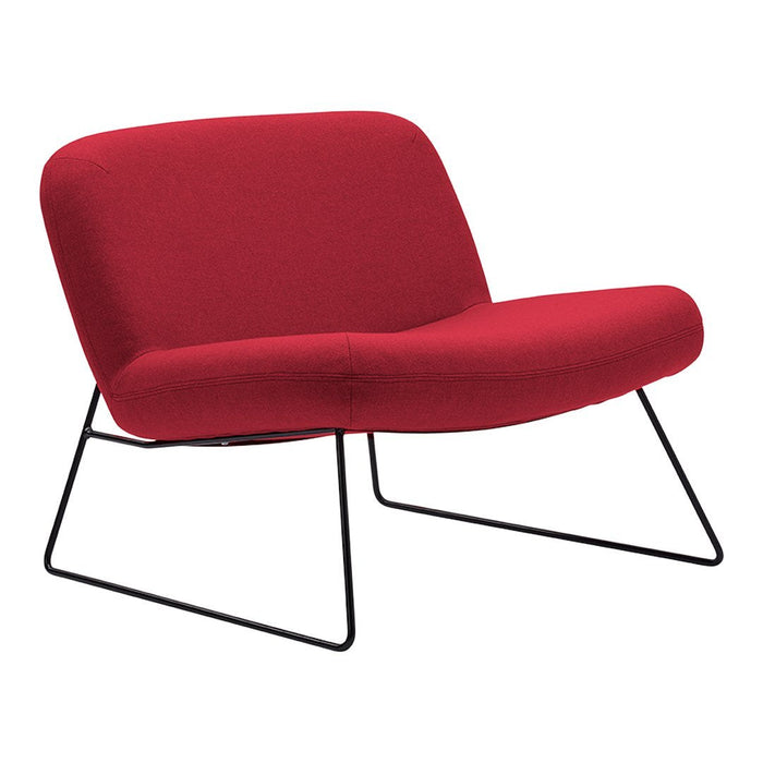 Red lounge chair with a smooth, curved design and minimalist black metal legs. Perfect for modern decor.