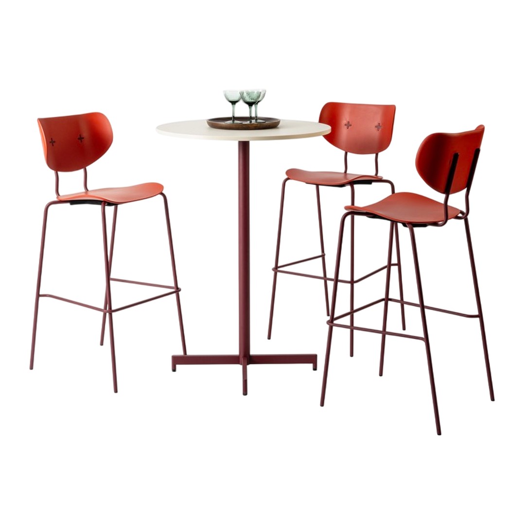 Red metal bar stools and table with a light wood top, featuring a minimalist design and modern aesthetic.