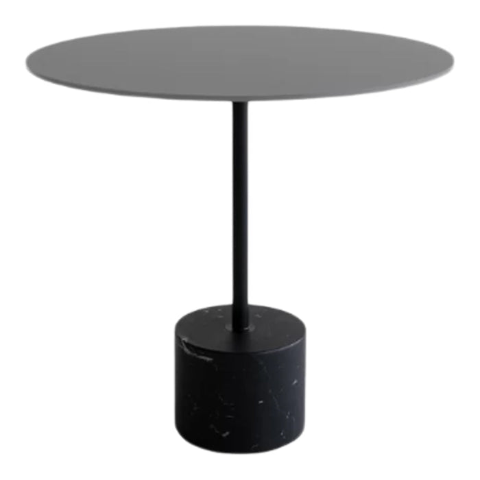 Round black coffee table with a smooth surface and cylindrical speckled base, perfect for modern decor.