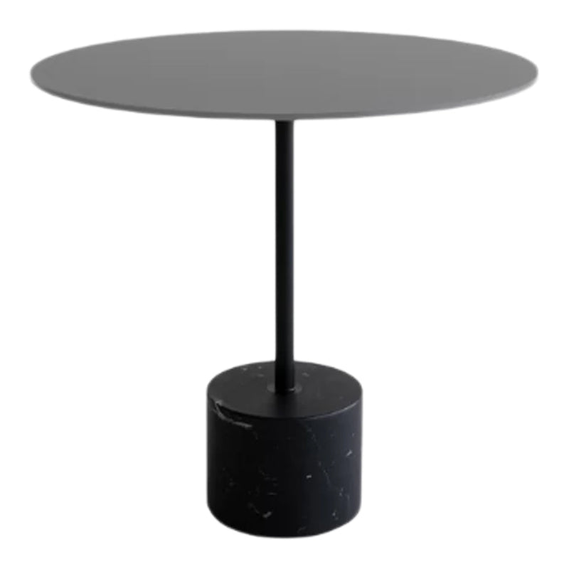 Modern round table in matte black with a solid black marble base, featuring a smooth, sleek design.