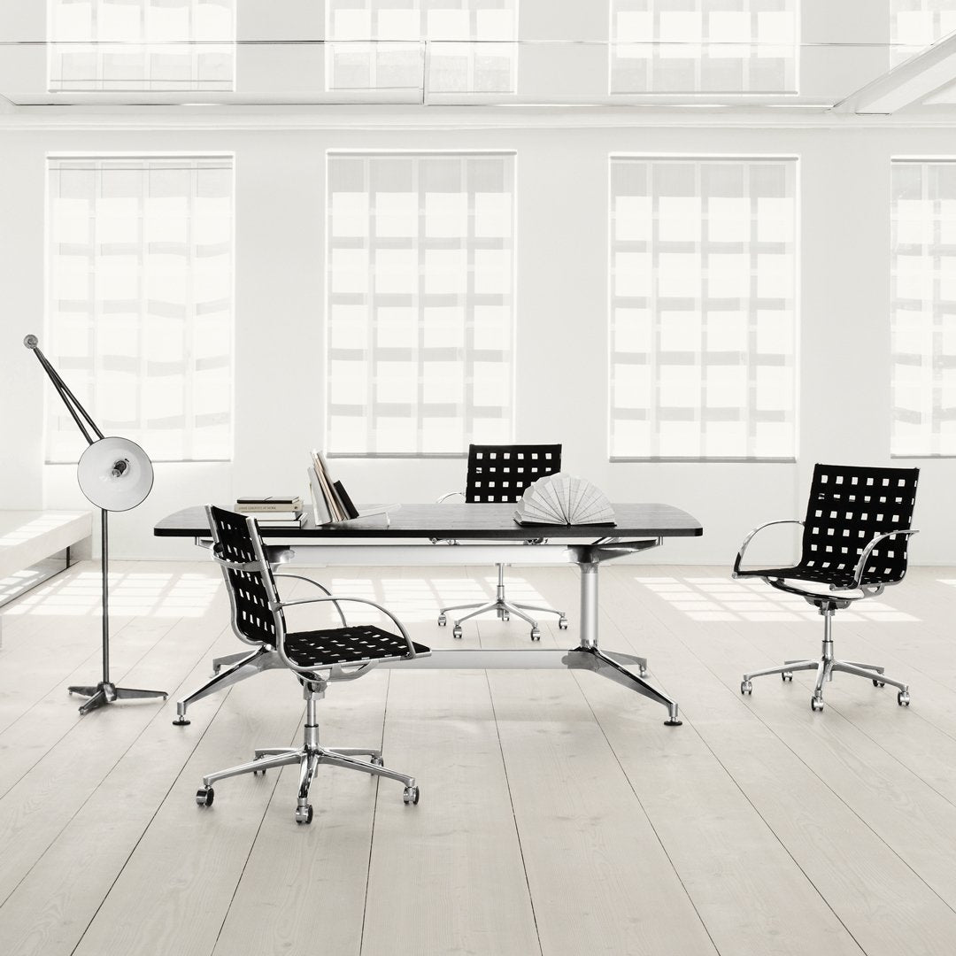 Modern black and white office furniture with polka dot patterns, sleek Chrome accents, and bright airy environment.