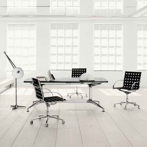 Modern black and white office furniture with polka dot patterns, sleek Chrome accents, and bright airy environment.