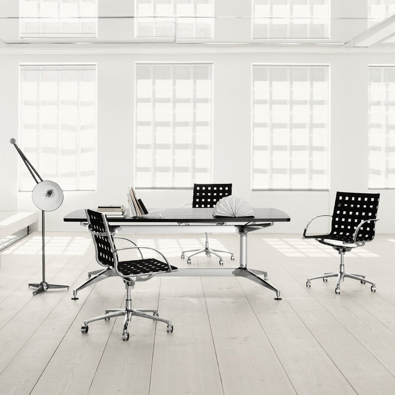 Modern black and white office furniture with polka dot patterns, sleek Chrome accents, and bright airy environment.
