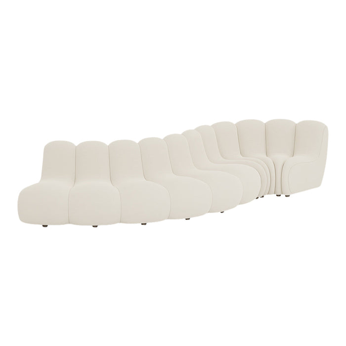 Curved cream-colored sofa with soft, smooth upholstery and minimalist design.