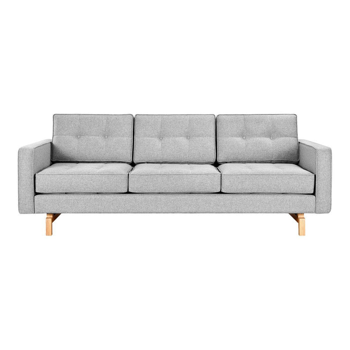 Light gray upholstered sofa with a tufted pattern and natural wood legs, perfect for modern living spaces.