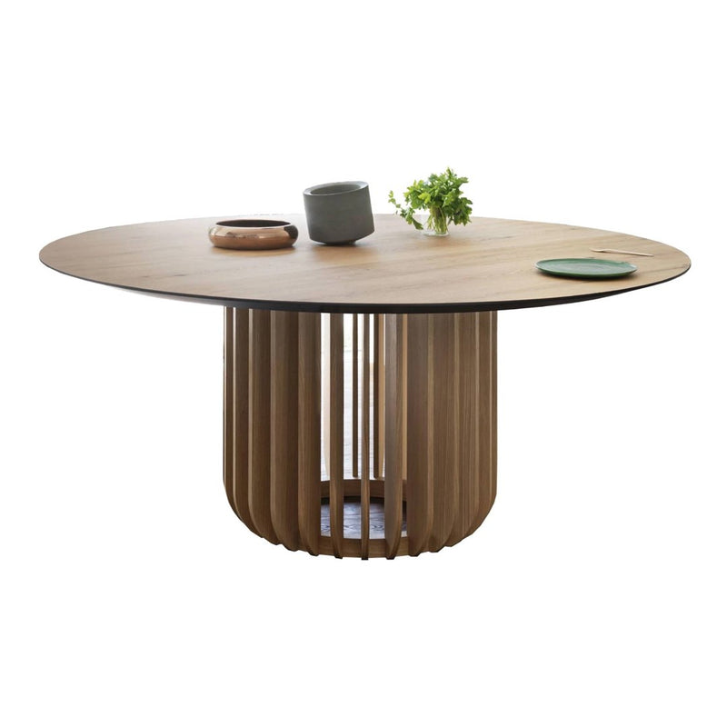 Round wooden dining table with natural wood tones and a slatted base, featuring minimalistic green and gray accents.