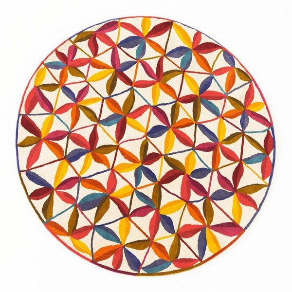 Colorful round decorative plate featuring a vibrant geometric pattern with red, yellow, orange, and purple hues.