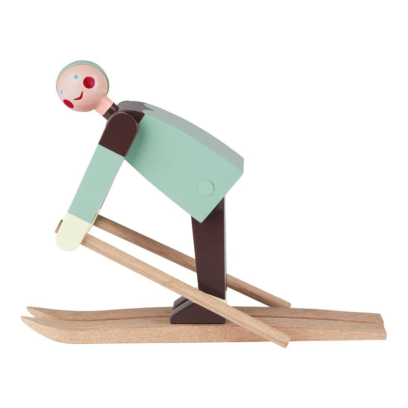 Colorful wooden skier figurine with a mint green body, brown skis, and a playful pink face. Perfect for decor.