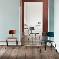 Colorful modern chairs in earthy tones of brown, green, and soft pastels against a minimalist backdrop.