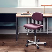 Plum upholstered office chair with a smooth, minimalist design on a light wood and black color palette.