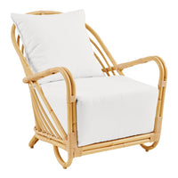 Light rattan chair with white cushions, featuring a sleek, minimalist design and natural wood tones.