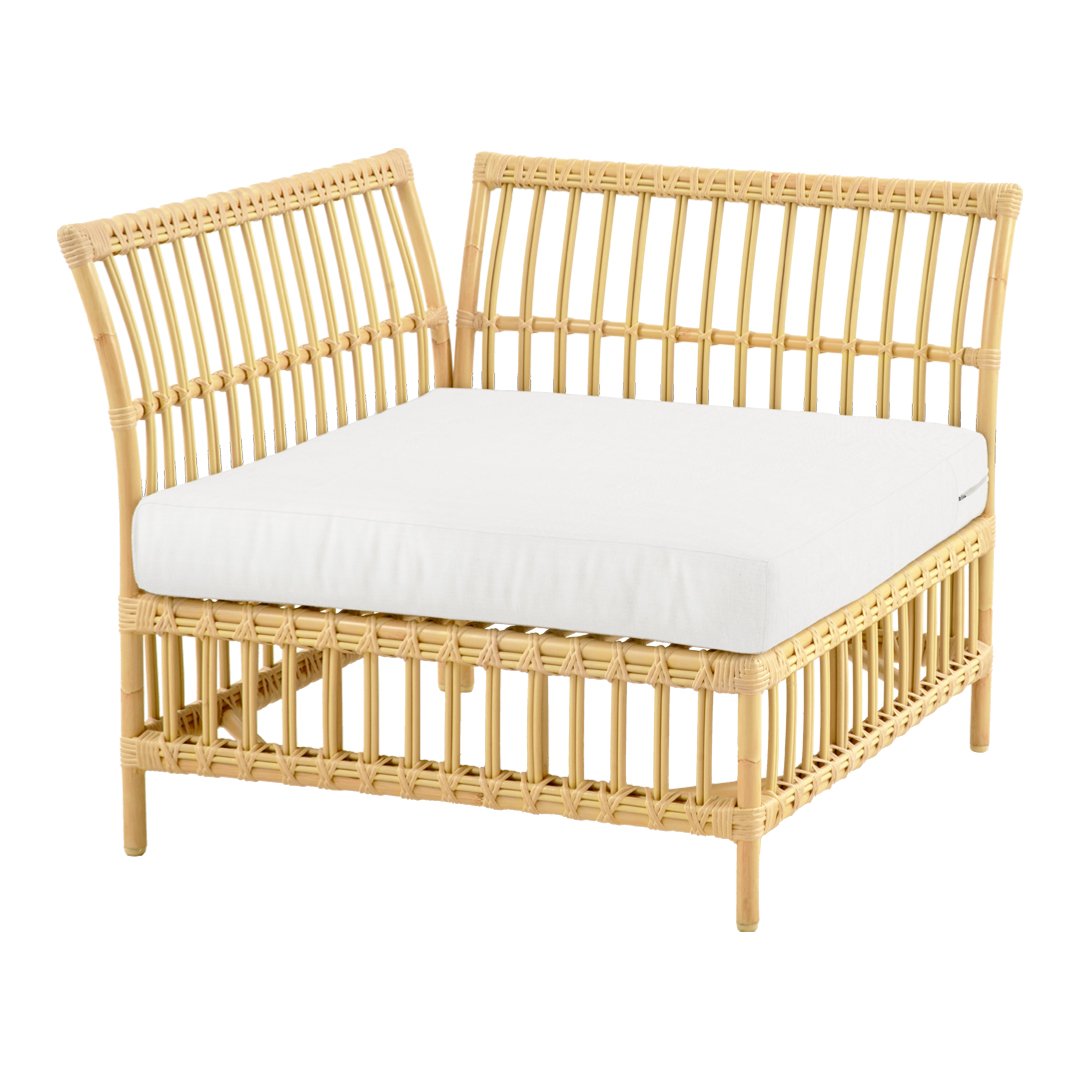 "Natural rattan chair with a light beige, removable cushion; modern, minimalist design with vertical slat pattern."