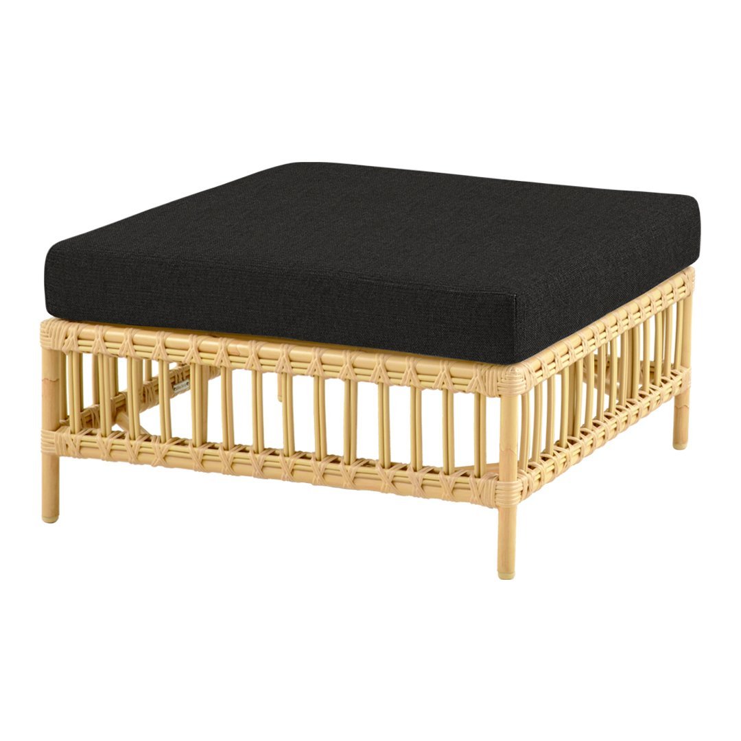 Black cushion atop a natural rattan frame, showcasing a sleek, modern, and minimalist design.